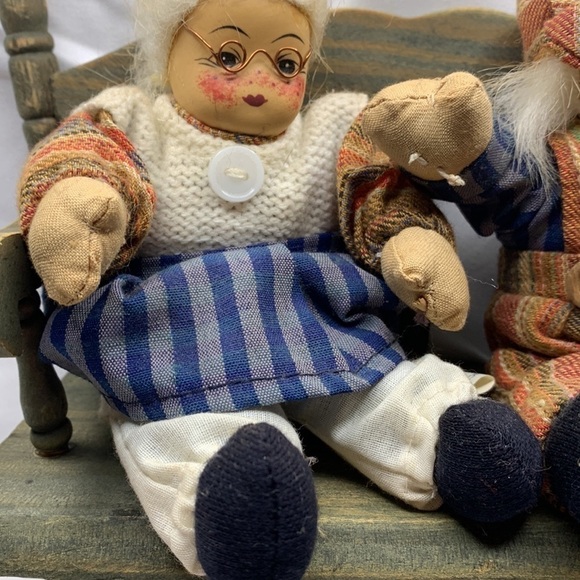 Grandma and grandpa sitting on a wooden bench - Picture 2 of 6